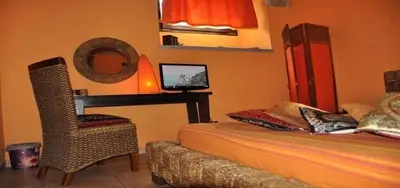 a bedroom with a bed and a desk with a computer at Shiva B&B in Rome