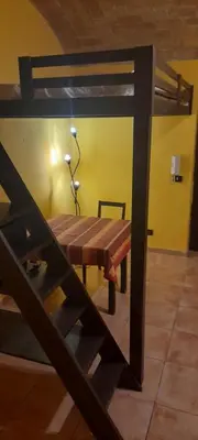 a dining room with a table and a bunk bed at Shiva B&B in Rome