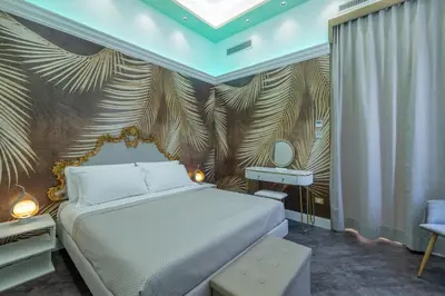 a bedroom with a bed and a wall with palm leaves at Antiqua Domus in Rome