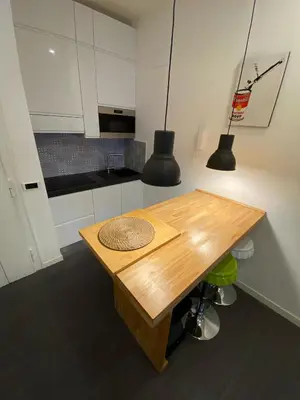 a kitchen with a wooden table and two lights at Apartment Villa Borghese with terrace in Rome