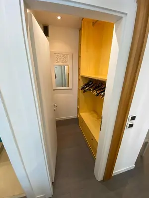 a walk in pantry with wooden cabinets and a closet at Apartment Villa Borghese with terrace in Rome