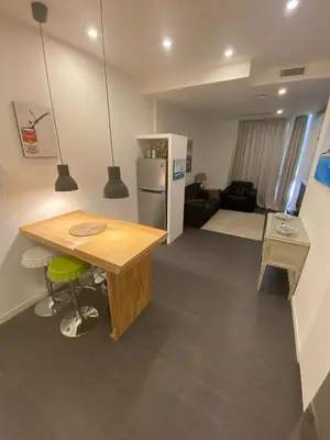 a kitchen and living room with a table and a refrigerator at Apartment Villa Borghese with terrace in Rome