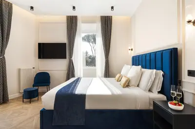 a hotel room with a bed and a tv at Adriana Boutique Guest House in Rome