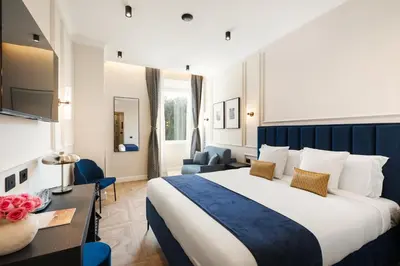 a hotel room with a large bed and a desk at Adriana Boutique Guest House in Rome