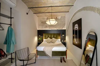 a bedroom with a bed and a chair in a room at Officina Daplace in Rome