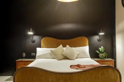 a bedroom with a large bed with a wooden headboard at Officina Daplace in Rome