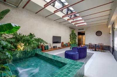a pool in the middle of a room with plants at Officina Daplace in Rome