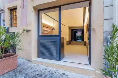 a door leading to a hallway with plants at Officina Daplace in Rome