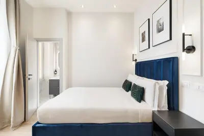 a bedroom with a large bed and a black table at Belli Boutique Guest House in Rome