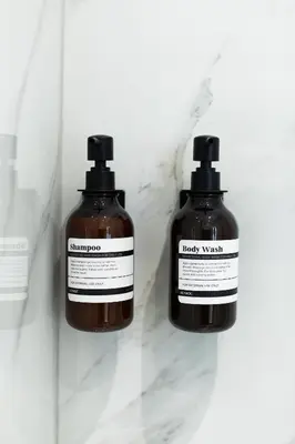 two bottles of hair products sitting on a counter at Belli Boutique Guest House in Rome