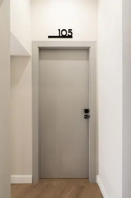 a white door with a sign on top of it at Sistina Boutique Guest House in Rome