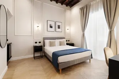 a bedroom with a bed with a blue blanket at Sistina Boutique Guest House in Rome
