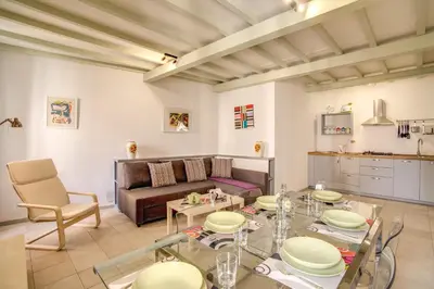 a living room with a table and a couch at Three Bedroom Apartment Campo dei Fiori in Rome