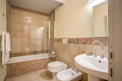 a bathroom with a toilet and a sink and a tub at Three Bedroom Apartment Campo dei Fiori in Rome
