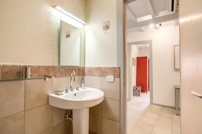 a bathroom with a sink and a mirror at Three Bedroom Apartment Campo dei Fiori in Rome