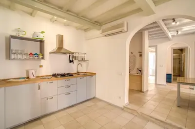 a kitchen with white cabinets and a counter top at Three Bedroom Apartment Campo dei Fiori in Rome