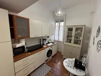 a kitchen with white cabinets and a microwave at La Casa di Rosa , Elegante Appartamento a Corso Trieste, Metro B in Rome