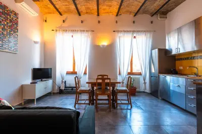 a kitchen and living room with a table and chairs at Casa Bodoni in Rome