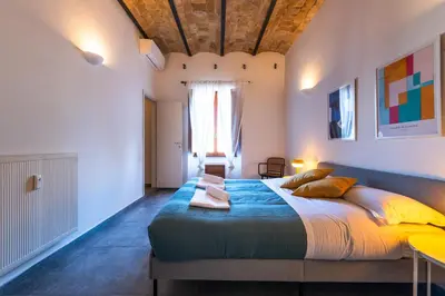a bedroom with a large bed and a window at Casa Bodoni in Rome