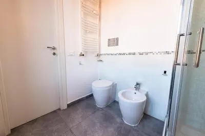 a bathroom with a toilet and a bidet at Casa Bodoni in Rome