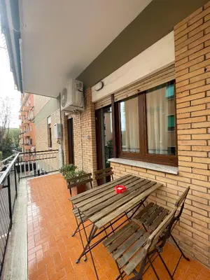 a wooden bench sitting on the side of a building at Trastevere Station Sweet Rest in Rome
