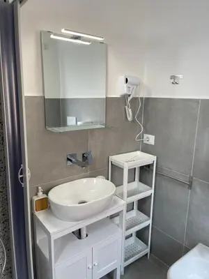 a bathroom with a white sink and a mirror at Trastevere Station Sweet Rest in Rome