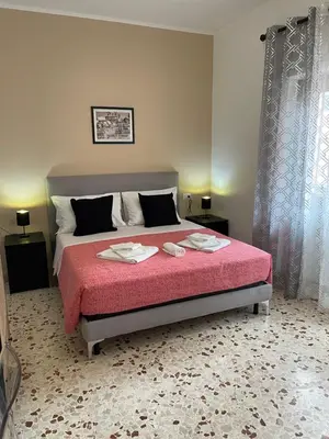 a bedroom with a large bed with a red blanket at Trastevere Station Sweet Rest in Rome