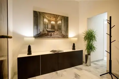 a room with a desk and a picture of a piano at The Right Place 4U Piemonte Apartment in Rome