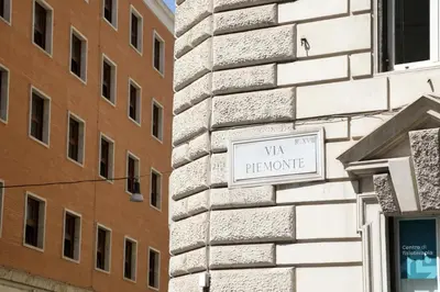 a sign on the side of a building at The Right Place 4U Piemonte Apartment in Rome
