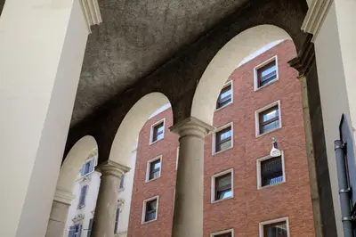 a brick building with arches and columns at The Right Place 4U Piemonte Apartment in Rome