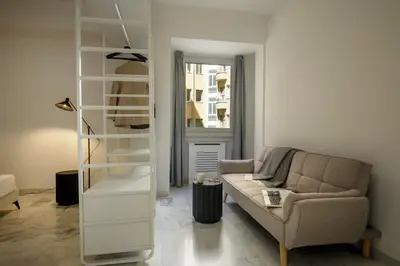 a living room with a couch and a shelf at The Right Place 4U Piemonte Apartment in Rome