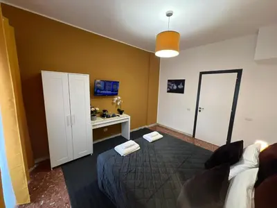 a bedroom with a bed and a desk in it at affittacamere appia nuova 639 in Rome
