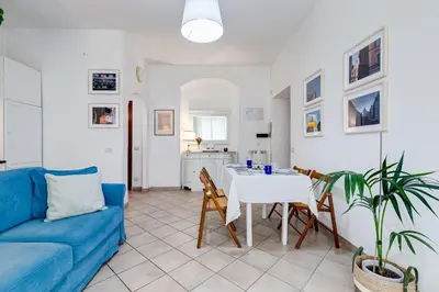 a living room with a blue couch and a table at Apartment Atelier Testaccio in Rome