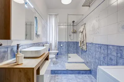 a bathroom with a sink and two toilets and a tub at Apartment Atelier Testaccio in Rome