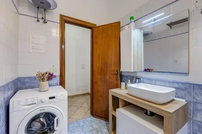 a bathroom with a washing machine and a sink at Apartment Atelier Testaccio in Rome