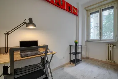 an office with a desk with a laptop computer on it at Ponte Milvio Apartment Flaminio in Rome