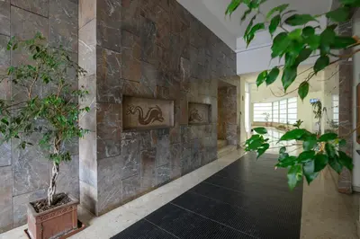 a hallway with a stone wall with a plant at Ponte Milvio Apartment Flaminio in Rome
