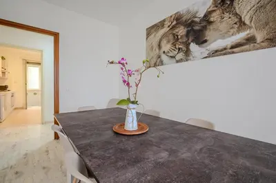 a vase with flowers on a table in a room at Ponte Milvio Apartment Flaminio in Rome