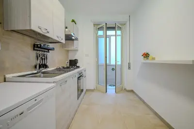 a white kitchen with a sink and a stove at Ponte Milvio Apartment Flaminio in Rome