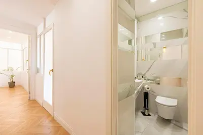 a white bathroom with a toilet and a sink at SJR Luxury Apartment Trevi Fountain in Rome
