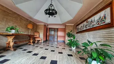 a room with a table and potted plants at Vinyle Apartment Vatican in Rome