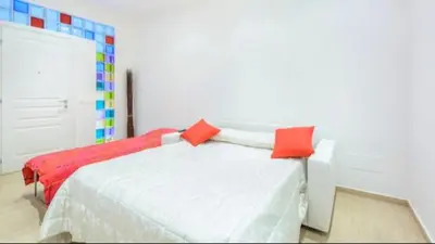 a bedroom with two beds with red pillows at Vinyle Apartment Vatican in Rome