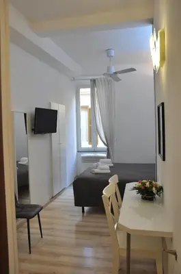 a living room with a bed and a table at Colosseo studios in Rome