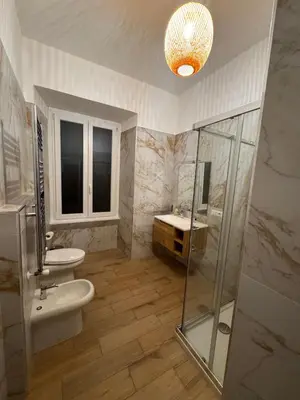a bathroom with a toilet and a sink and a shower at Angolo Vaticano - Vatican corner in Rome