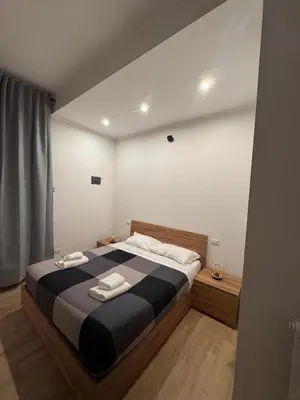 a bedroom with a large bed with two towels on it at Angolo Vaticano - Vatican corner in Rome