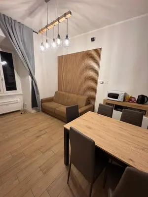 a living room with a table and a couch at Angolo Vaticano - Vatican corner in Rome