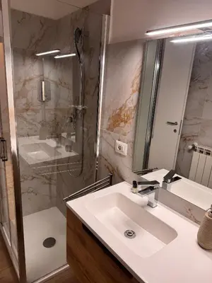 a bathroom with a sink and a shower at Angolo Vaticano - Vatican corner in Rome