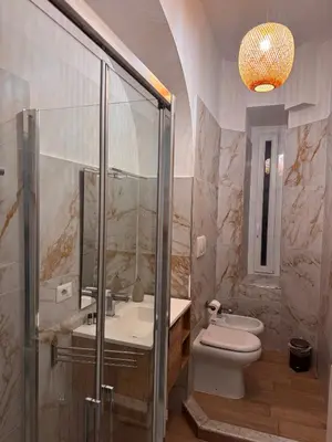 a bathroom with a shower and a toilet and a sink at Angolo Vaticano - Vatican corner in Rome