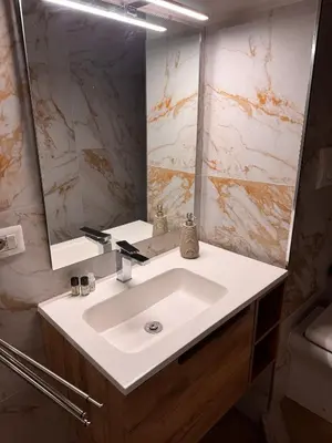 a bathroom with a white sink and a mirror at Angolo Vaticano - Vatican corner in Rome