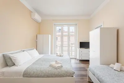 a bedroom with a bed with a towel on it at Prati Grabau Comfort 3 rooms apt in Rome